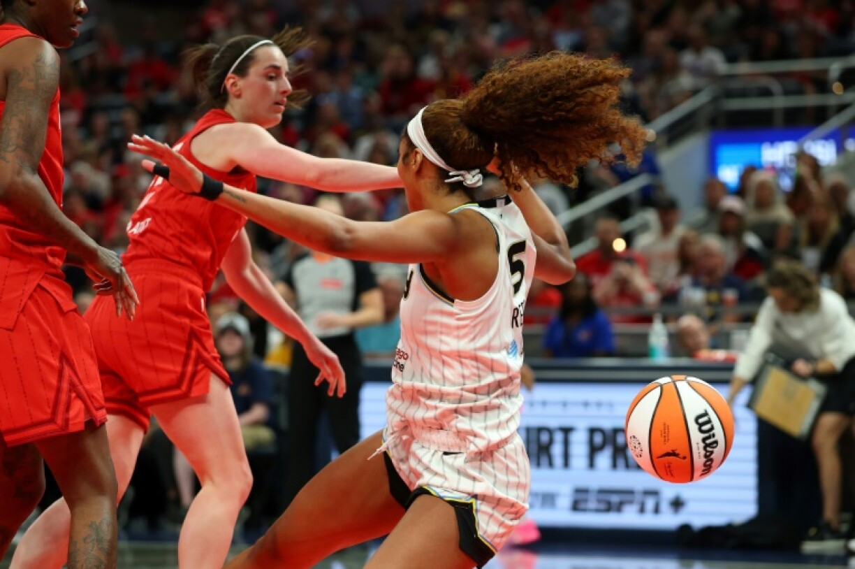 Chicago's Angel Reese (right) is fouled by Indiana's Caitlin Clark (center) in their season-opening WNBA clash