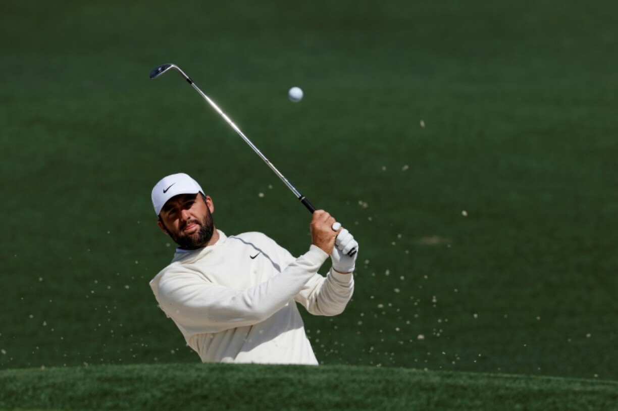 Top-ranked defending champion Scottie Scheffler of the United States plays a shot from a second-hole bunker during a practice round at Augusta National ahead of the 89th Masters