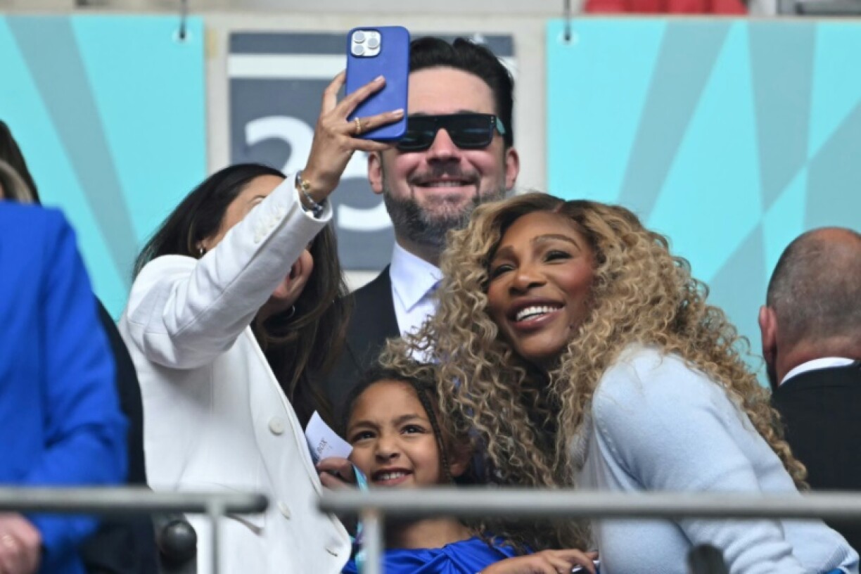 Famous fans: US tennis legend Serena WIlliams (R) poses for a selfie photograph with her daughter Olympia and husband Alexis Ohanian (C), a new investor in Chelsea, ahead of the Blues' 3-0 Women's FA Cup final win over Manchester United at Wembley