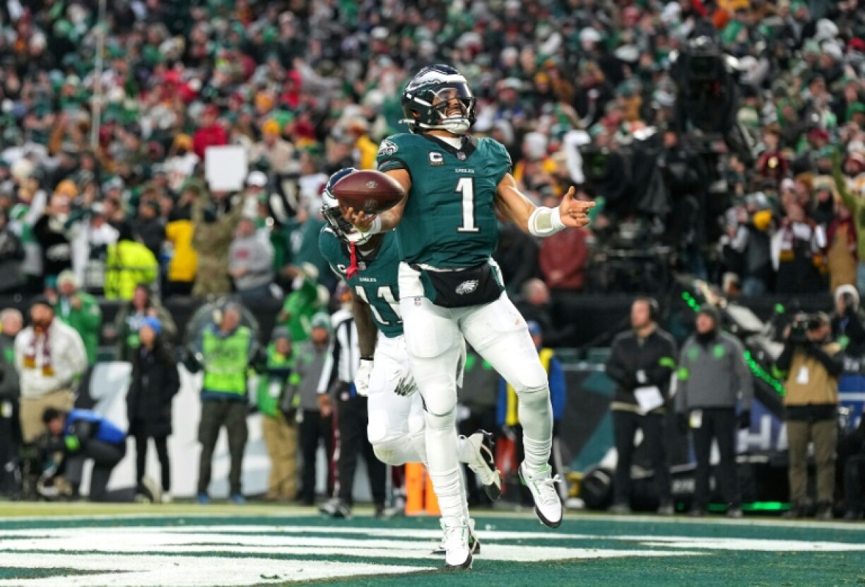 Philadelphia quarterback Jalen Hurts celebrates a touchdown run alongside teammate A.J. Brown n the Eagles' victory over the Washington Commanders in the NFL's NFC championship game