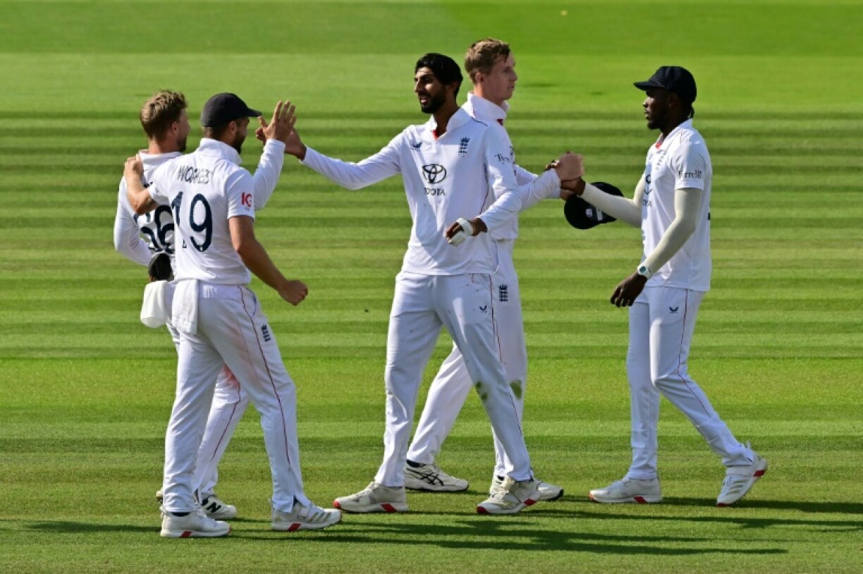 England's Shoaib Bashir (C) celebrates with team-mates Chris Woakes and Joe Root (L) after taking the clinching wicket in a 22-run win over India in the third Test at Lord's