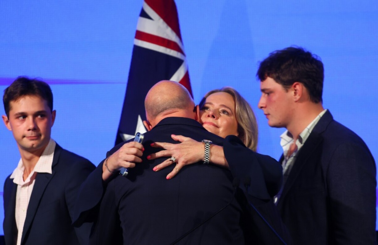 Australia's Opposition Leader Peter Dutton is hugged by his wife Kirilly Dutton beside their sons Tom and Harry after conceding defeat in a general election.