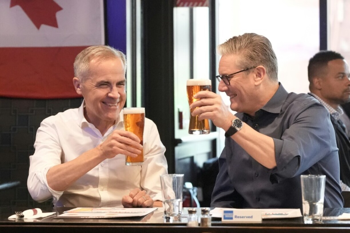 British Prime Minister Keir Starmer and Canadian Prime Minister Mark Carney have a beer at the Royal Oak pub in Ottawa, Canada