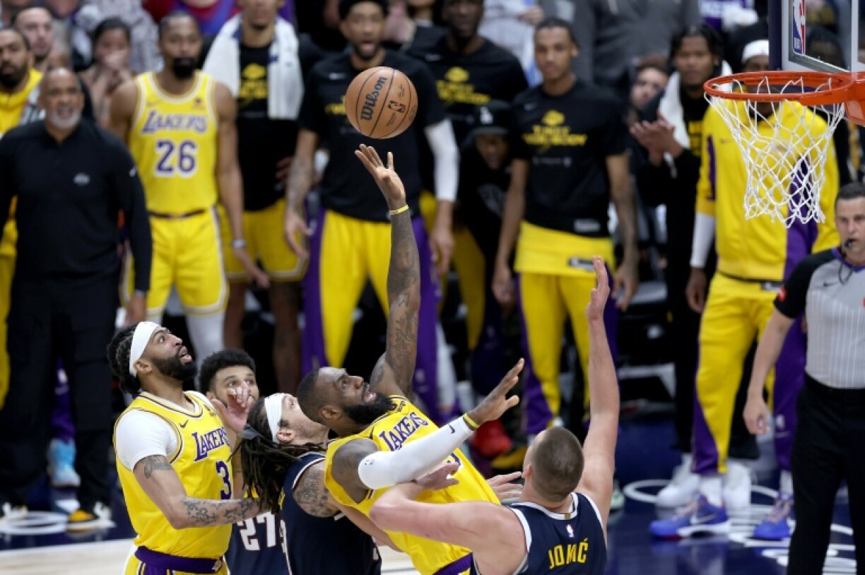 LeBron James (G) à la lutte avec Nikola Jokic (D) lors du match 5 des play-offs de NBA entre son équipe des LA Lakers et les Nuggets, le 29 avril 2024 à Denver