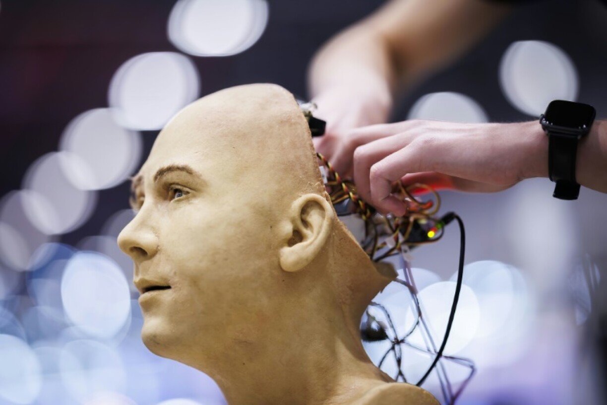 A man works on the electronics of Jules, a humanoid robot from Hanson Robotics using AI, at the recent International Telecommunication Union AI for Good Global Summit in Geneva