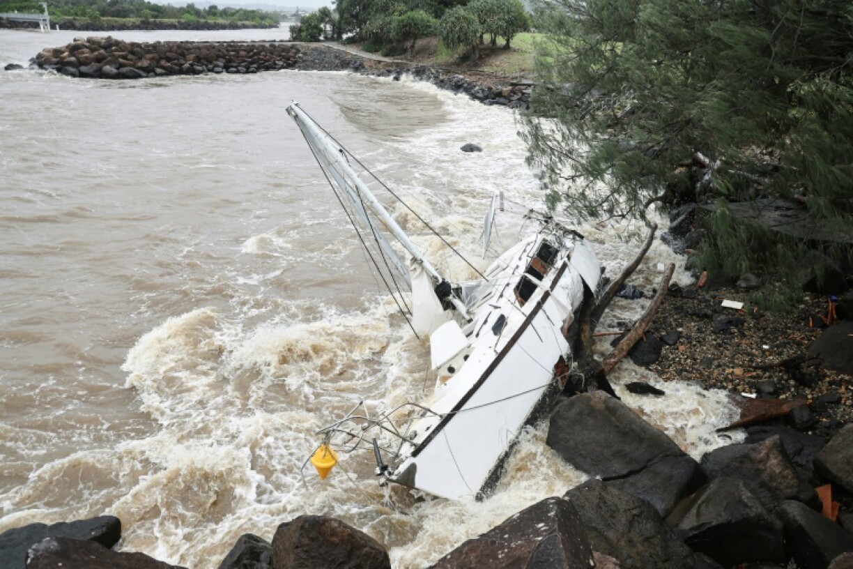 A yacht swept away by the waves rests at Point Danger on the southern end of the Gold Coast
