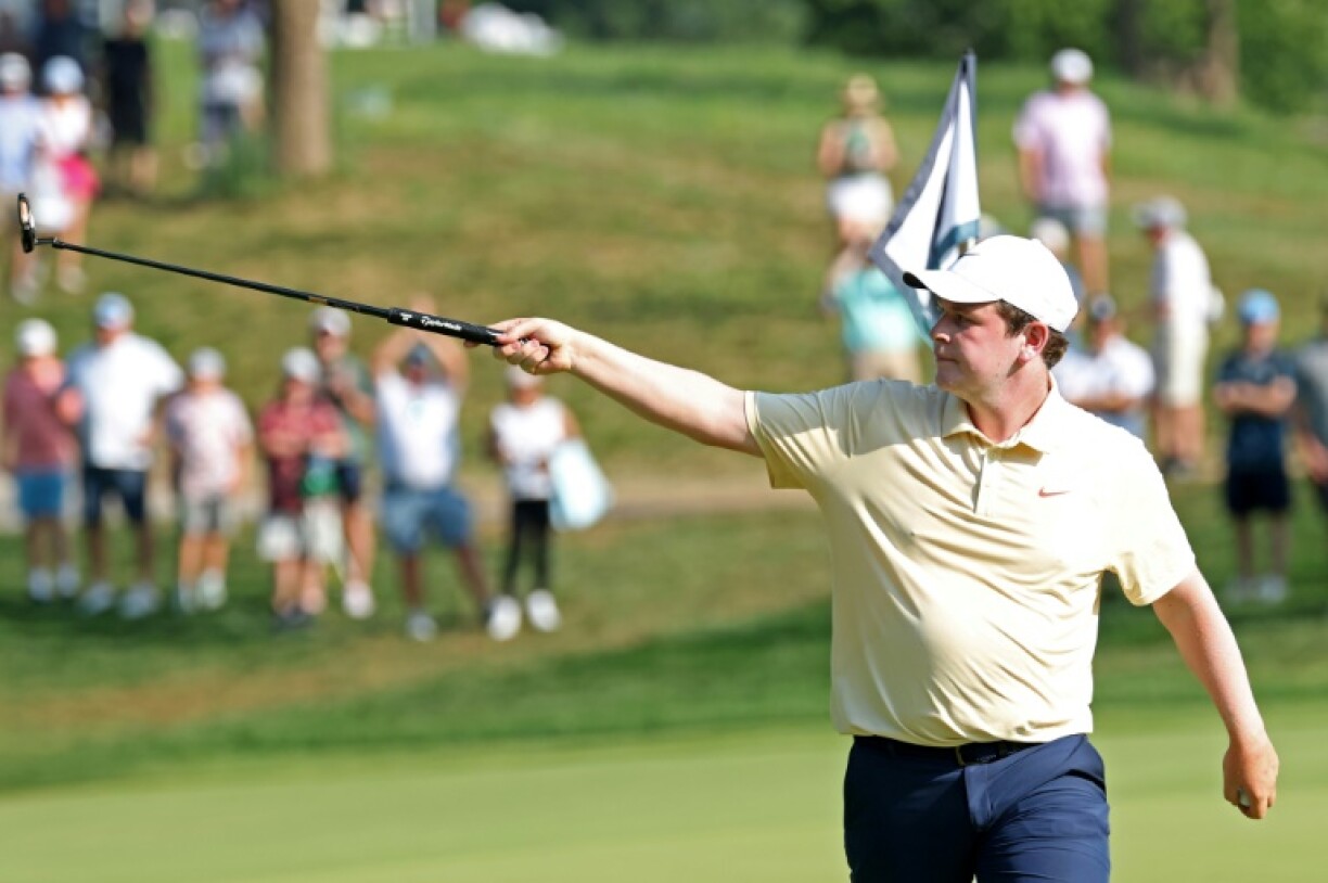 Scotland's Robert MacIntyre points out a heckler after making a clutch par putt at the 14th hole on his way to a four-stroke lead after the third round of the US PGA Tour BMW Championship