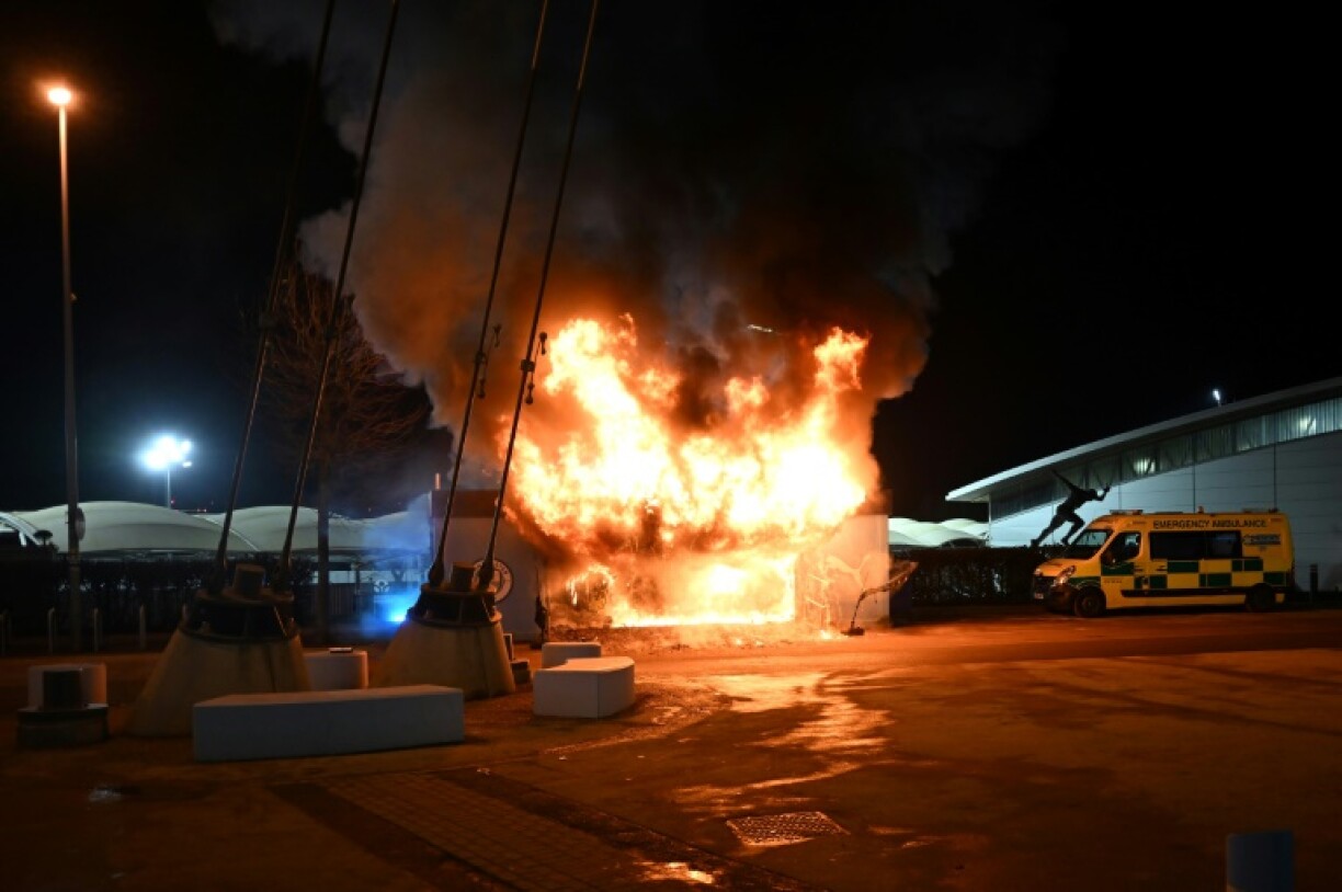 Flames engulf a merchandise stall outside Manchester City's Etihad Stadium