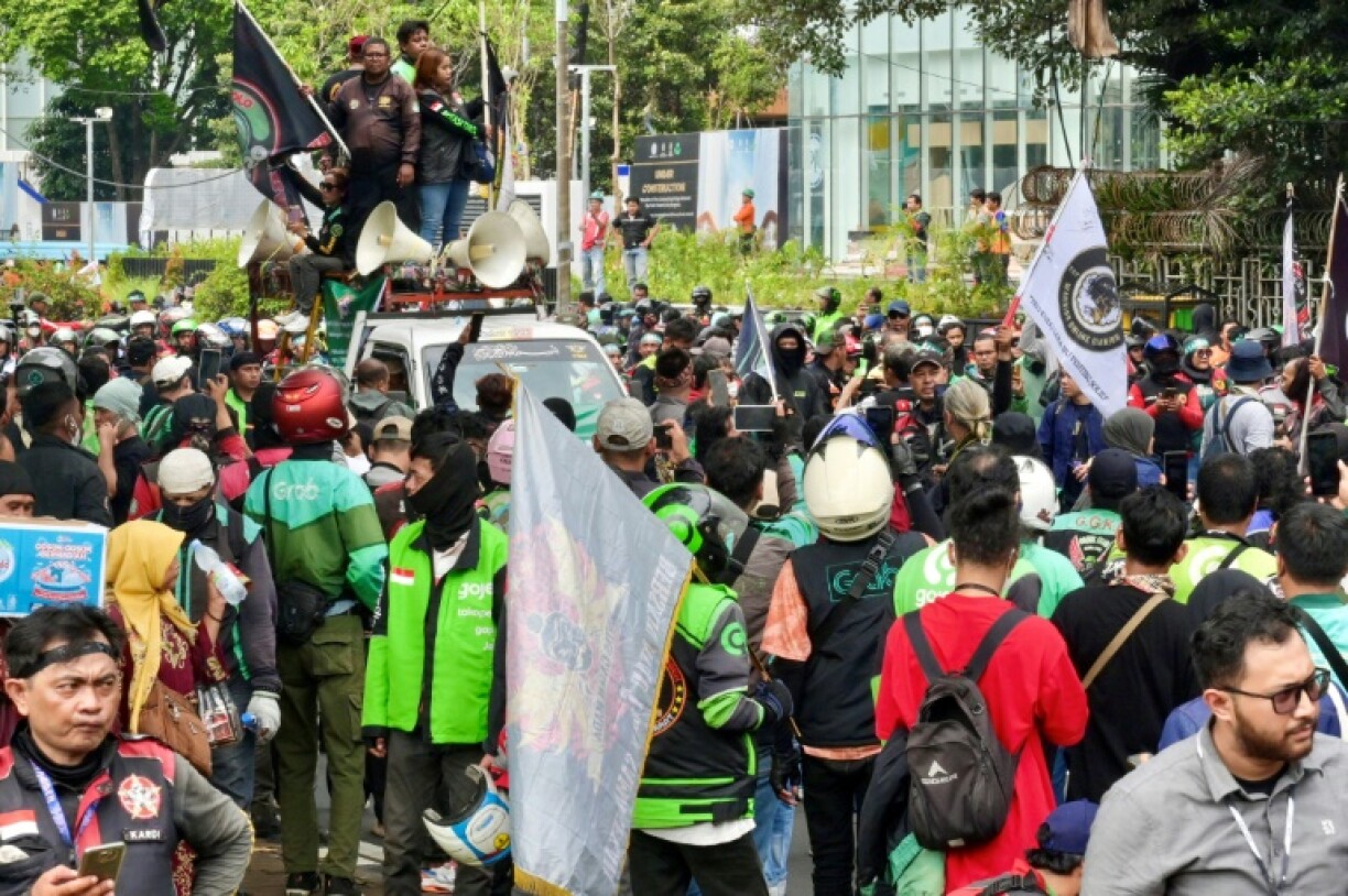 Drivers who form the backbone of Indonesia's sprawling gig economy earn up to 150,000 rupiah ($10) a day