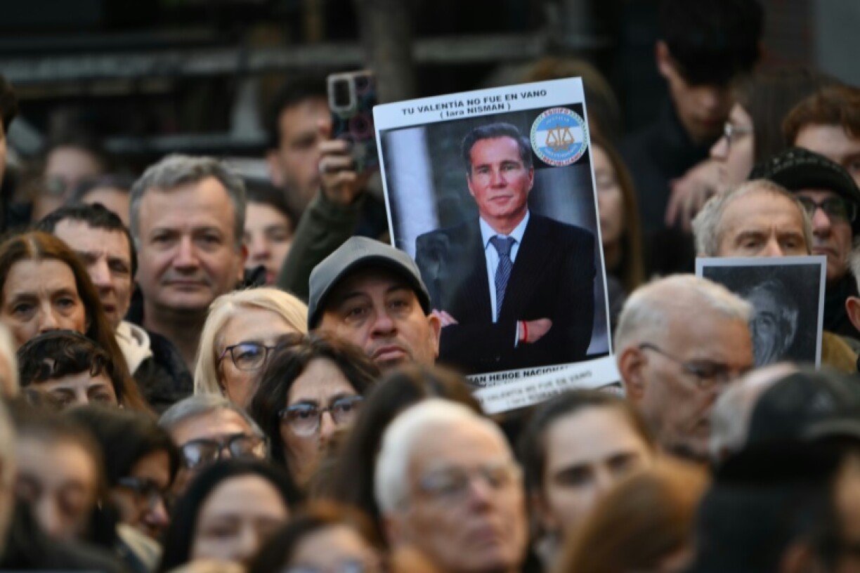 Prosecutor Alberto Nisman (pictured on poster) investigated an alleged cover-up in the bombing, but was found murdered