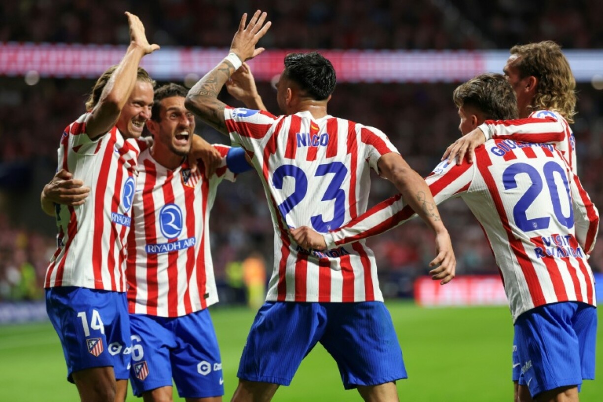 Atletico Madrid's Argentine midfielder Nico Gonzalez celebrates with team-mates after scoring their second goal against Villarreal