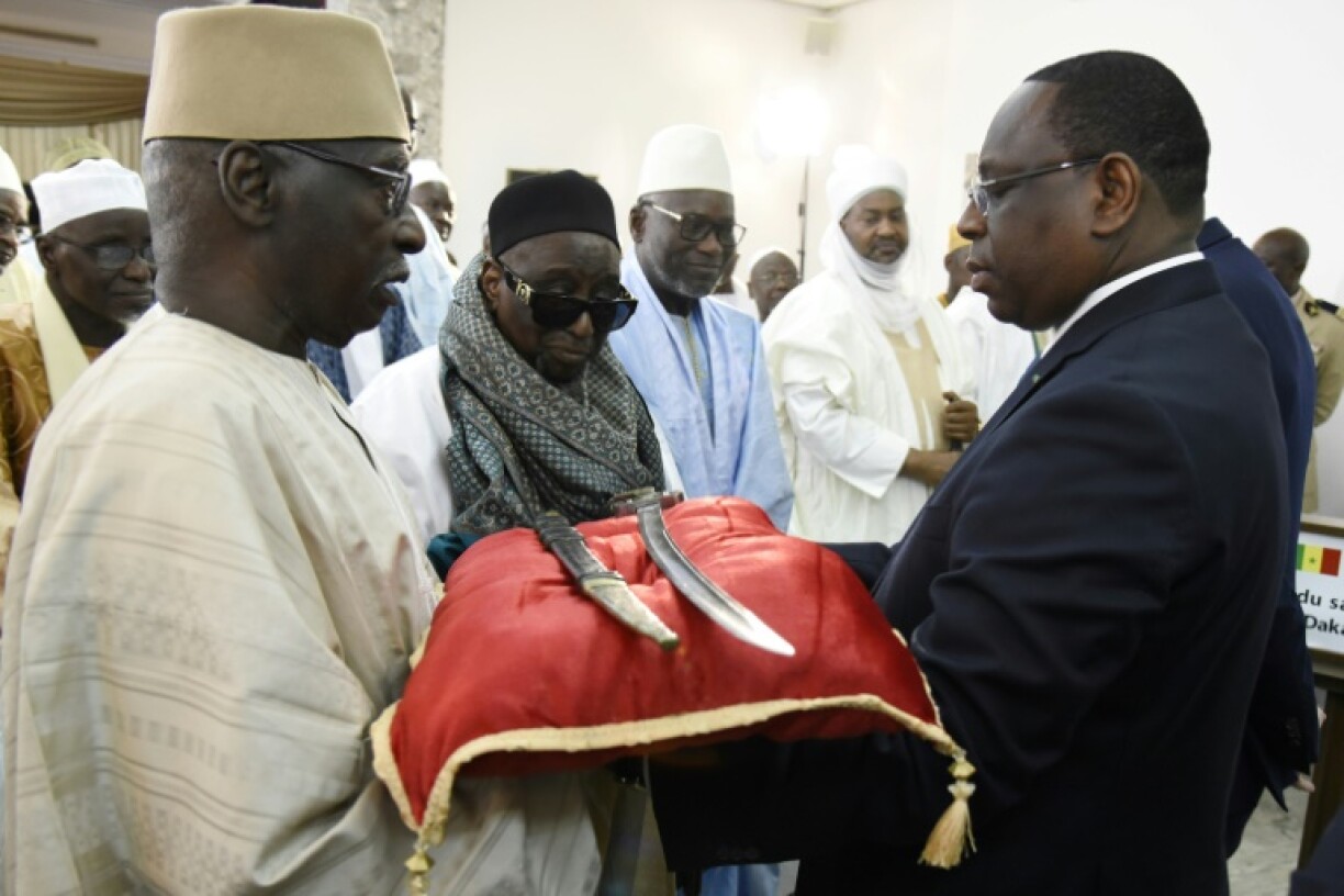 In 2019, France returned a 19-century sword to Senegal's then president Macky Sall (right)