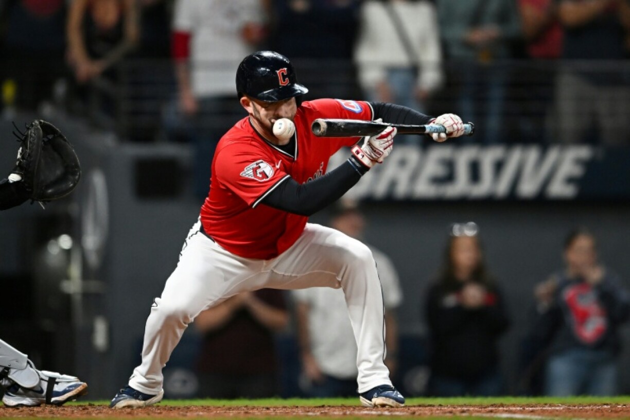 David Fry of the Cleveland Guardians takes a ball to the face as he attempts to bunt in a Major League Baseball game against the Detroit Tigers