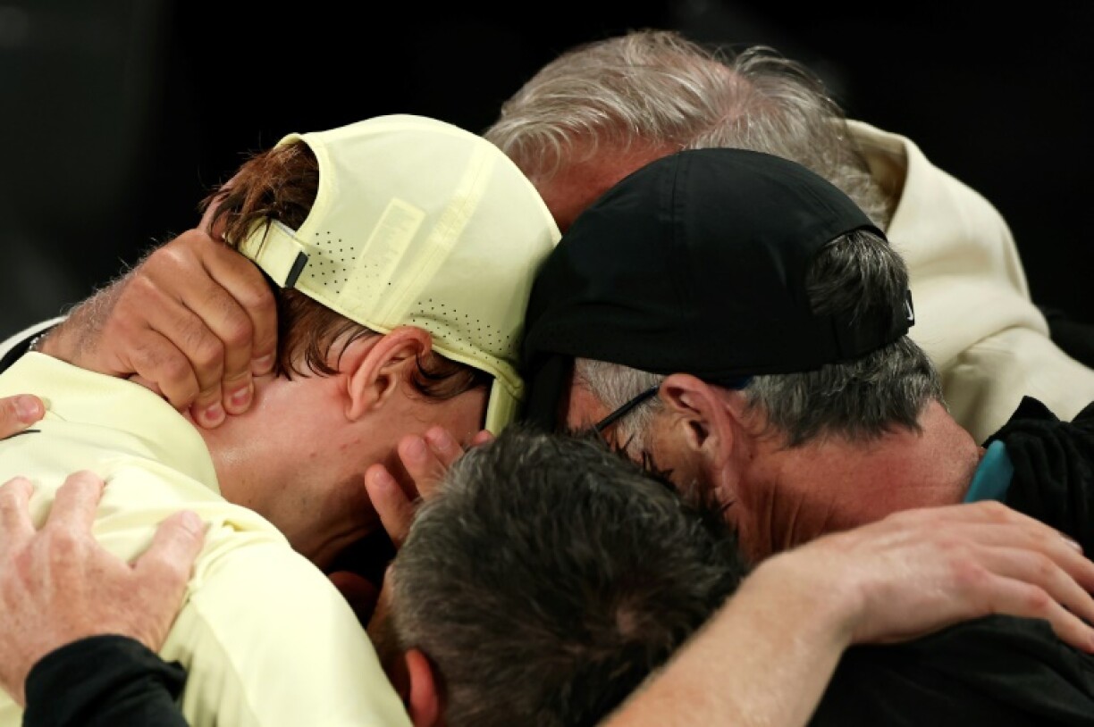 Jannik Sinner (L) celebrates his Australian Open victory with his coaching team