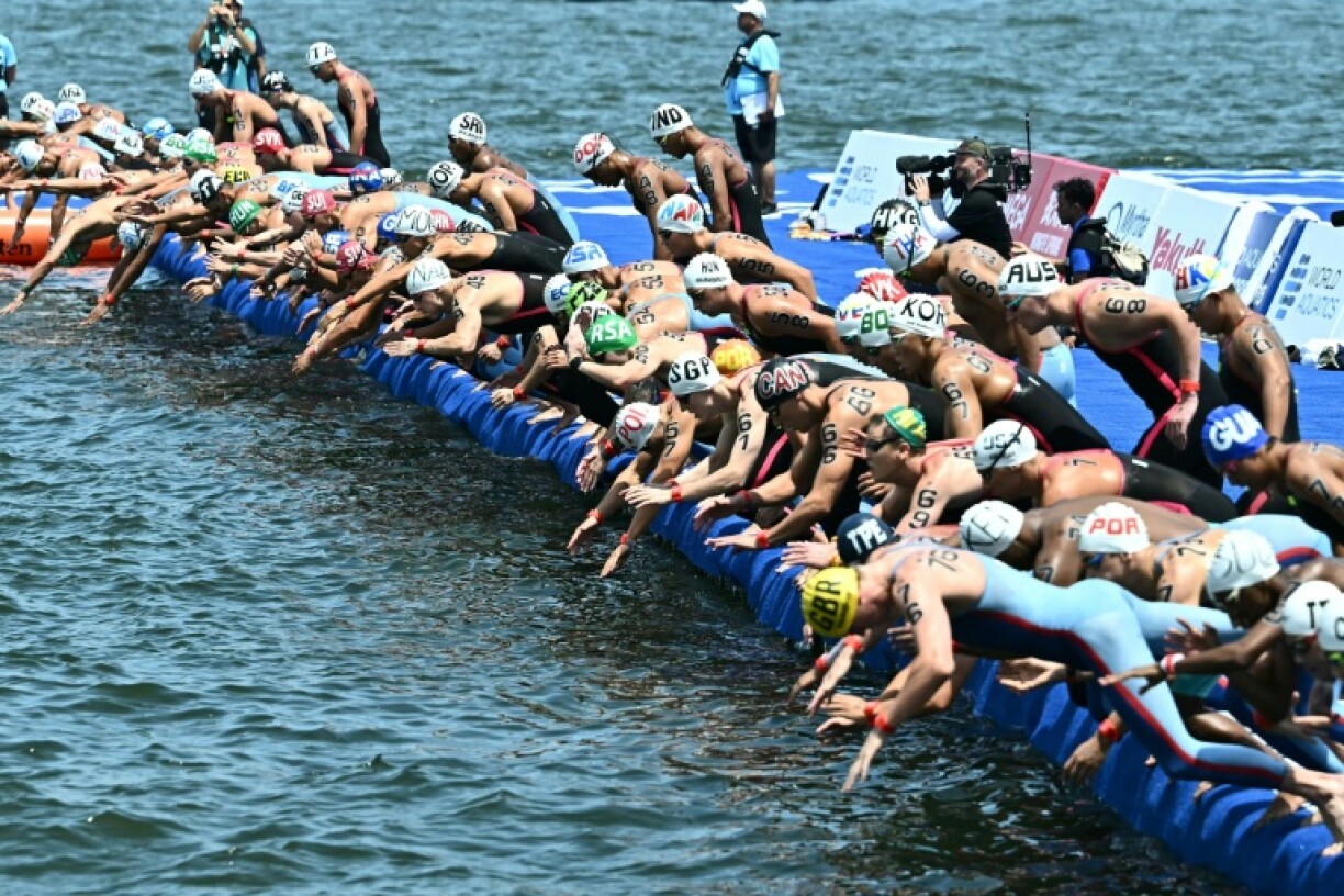 Swimmers start the men's 10km during the World Aquatics Championships which had been held up because of water quality fears on the course at Sentosa Island