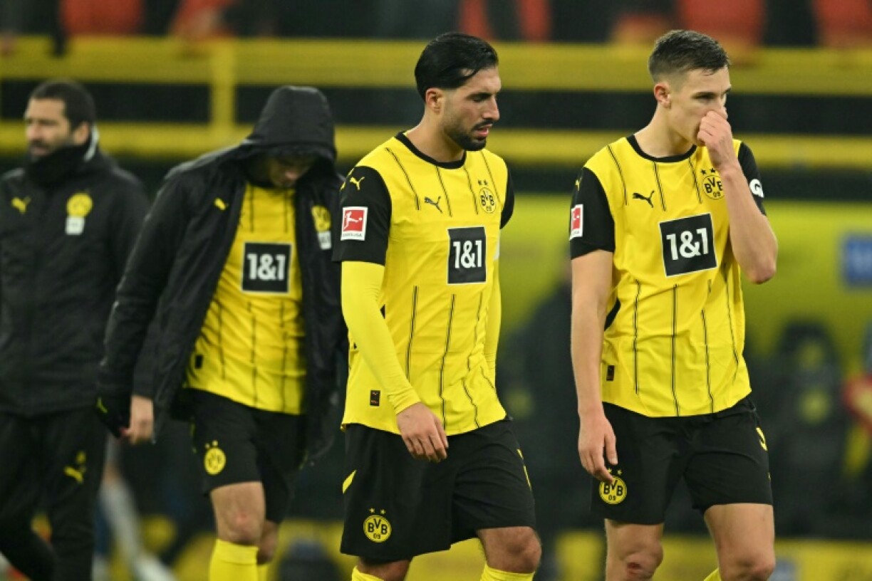 Disappointed Dortmund players leave the field after Sunday's 1-1 draw at home against Hoffenheim