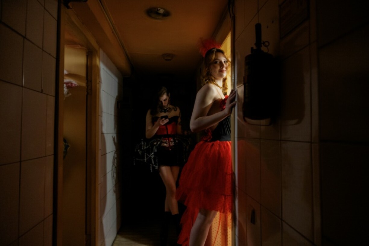 Lisa smiles before entering the dressing room at the strip club 'Flash Dancers'