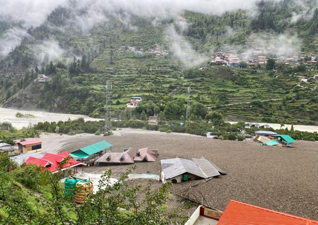 A handout photograph released by the Indian Army shows residential buildings partially submerged in sludge after the mudslide in Uttarakhand