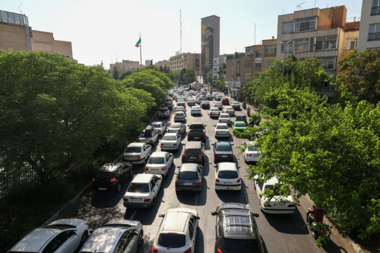 Vehicles await in traffic as people leave Tehran on June 15, 2025