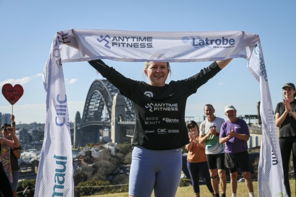 Ultra long-distance runner Fran Hurndall completed a 3,800-kilometre (2,360-mile) charity run across Australia in Sydney, claiming the fastest time on record for a woman