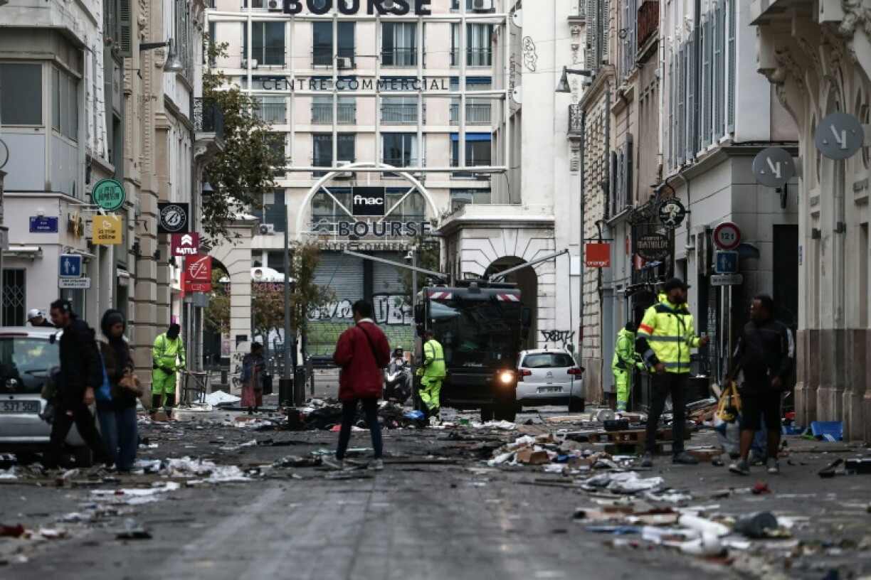 Municipal workers clean up the mess after a dekmonstration in the southern city of Marseille