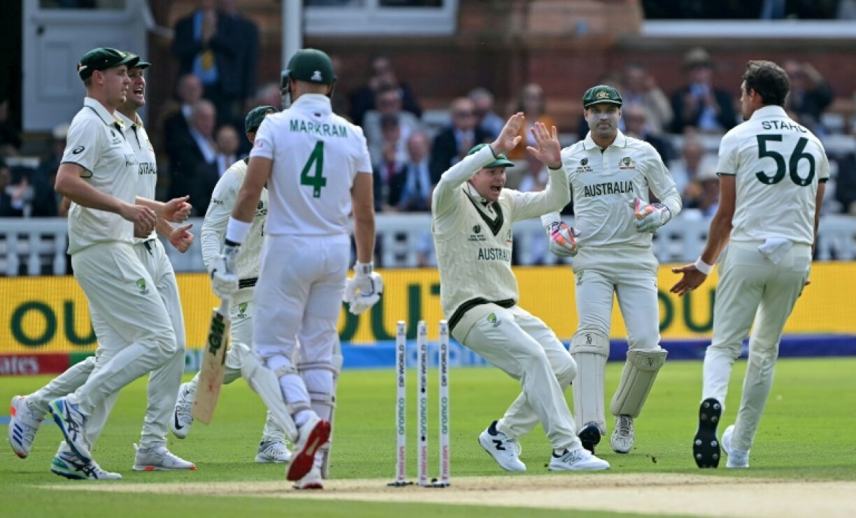 Australia's Mitchell Starc celebrates with Steve Smith (C) after dismissing South Africa's Aiden Markram
