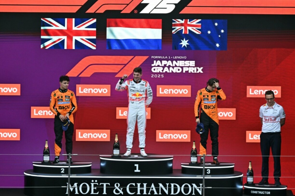 Lando Norris (left), winner Max Verstappen (centre) and Oscar Piastri celebrate on the podium