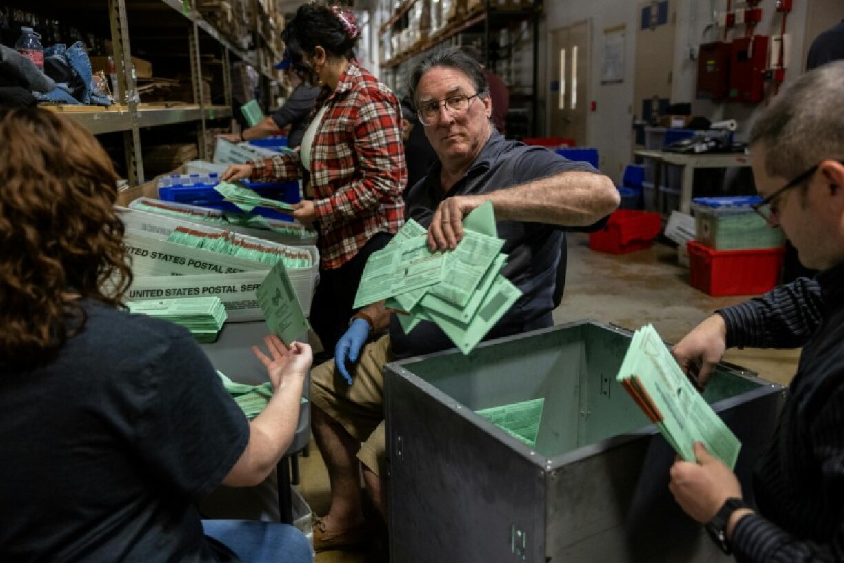 Election workers sort mail ballots at the Maricopa County Tabulation and Election Center on November 8, 2022 in Phoenix, Arizona