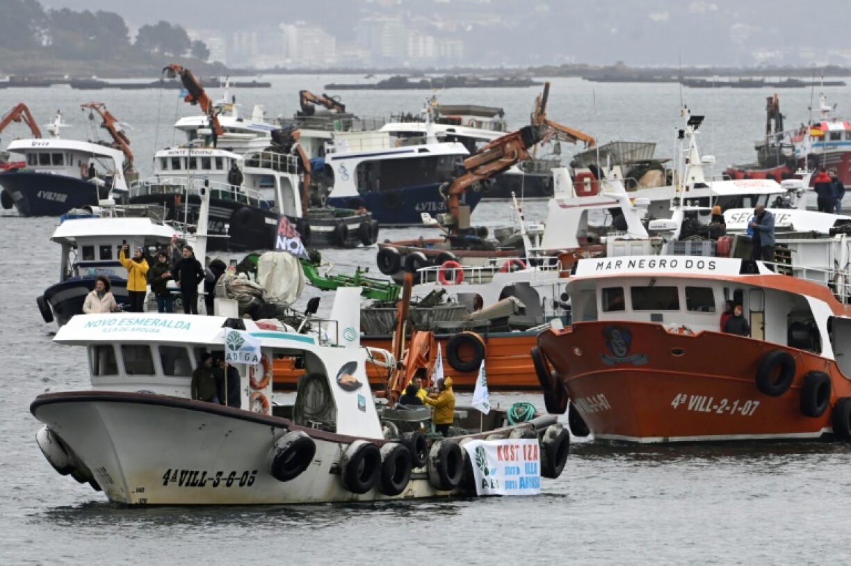 Demonstrators on boats protested the planned textile factory and the reopening of a copper mine