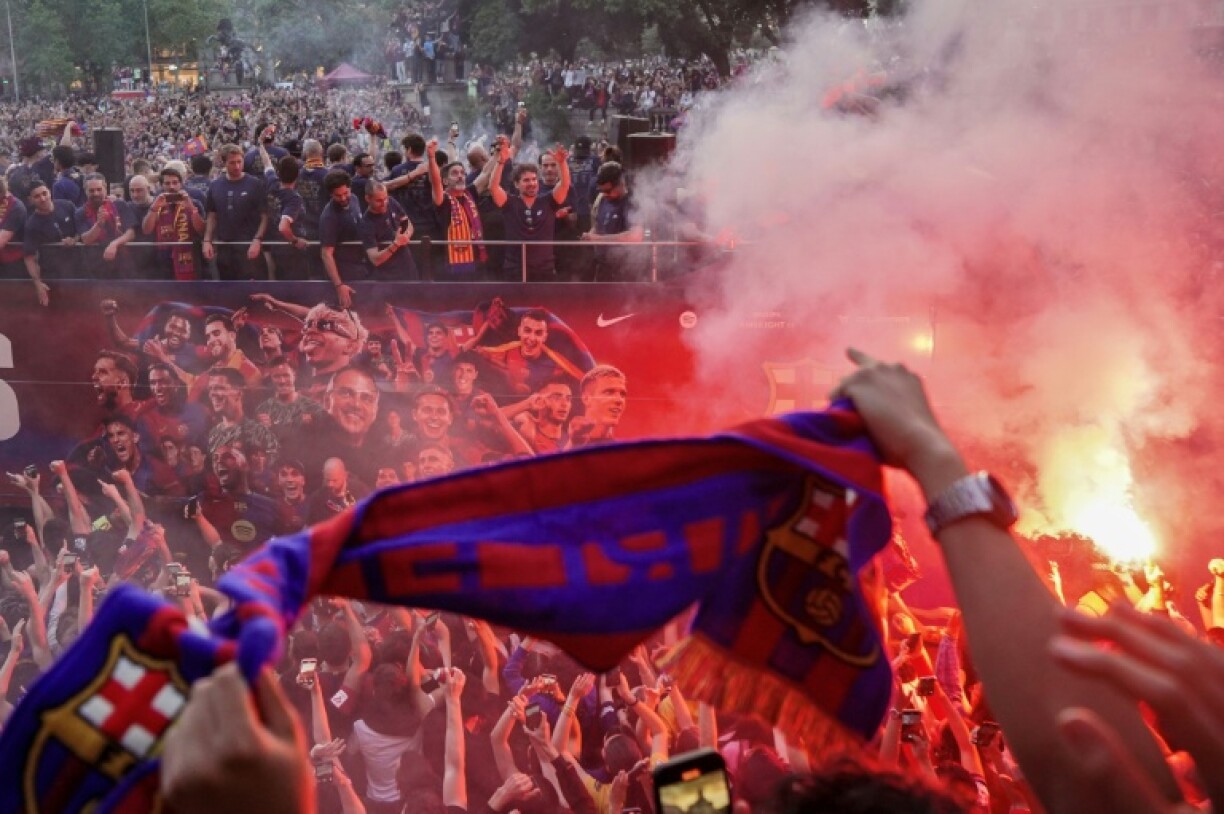 Barcelona players ride in an open top bus to celebrate winning their 28th La Liga title