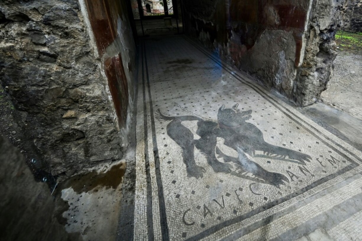 A mosaic outside a home in the ancient Roman city of Pompeii reading: