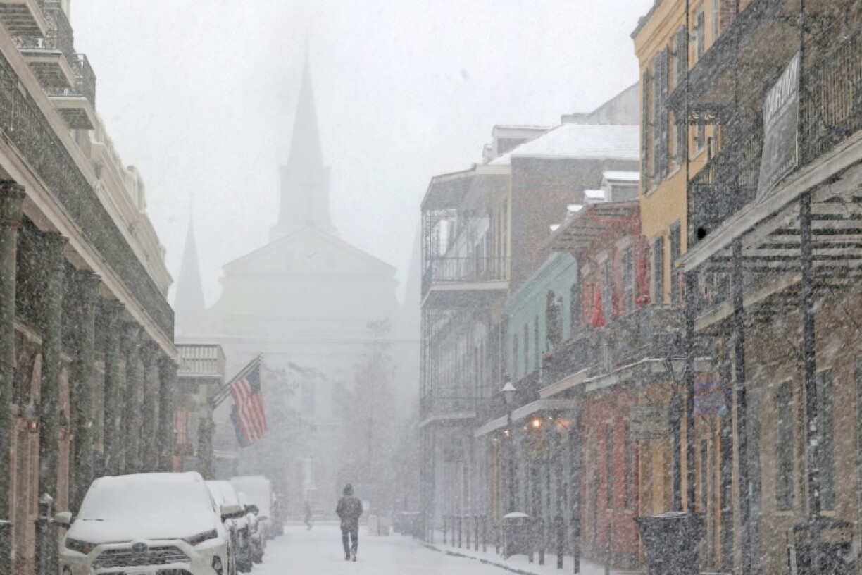 A cathedral in the French Quarter of New Orleans is barely visible in heavy snow that has blanketed the southern US city in a rare winter storm