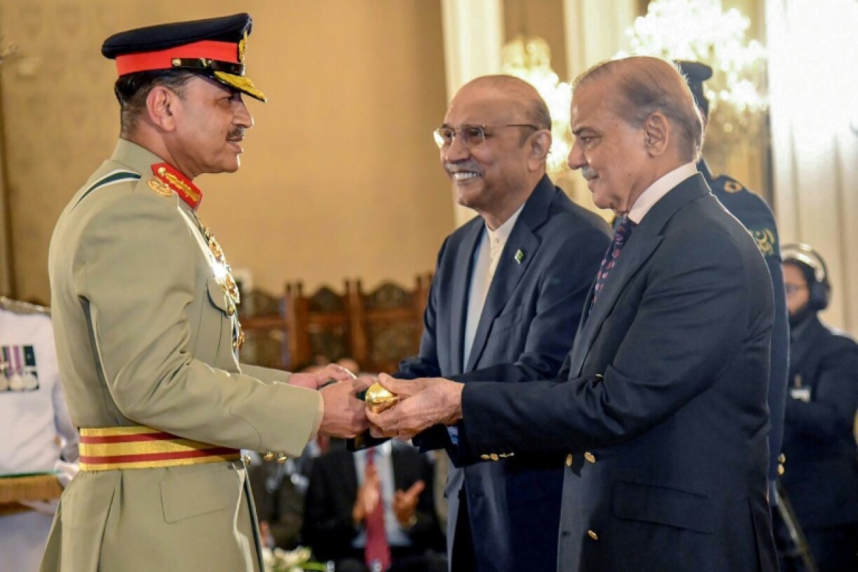 Asim Munir, left, receiving his field marshal baton from President Asif Ali Zardari, centre, and Prime Minister Shehbaz Sharif in May