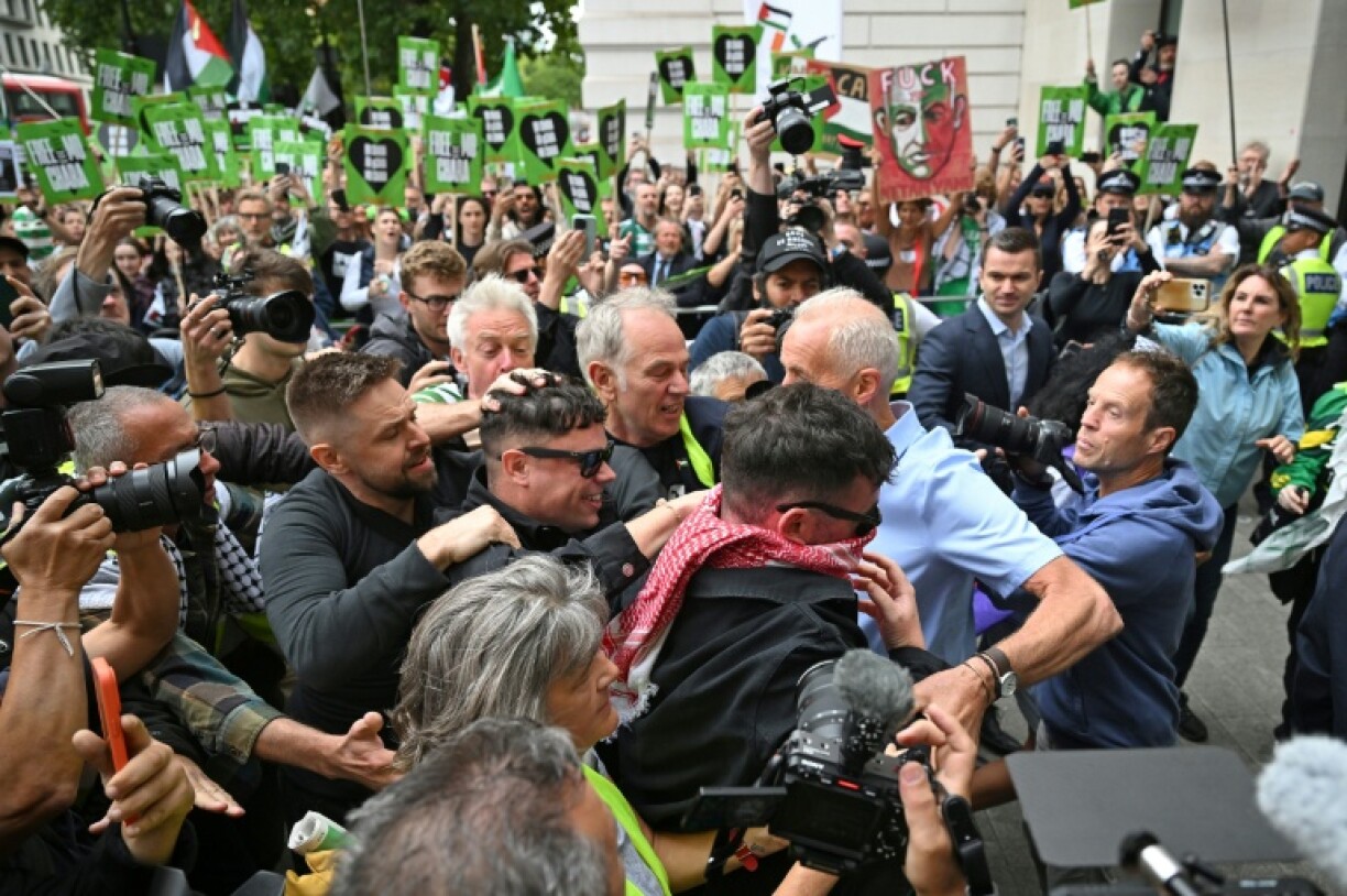 Irish rap group Kneecap band member, Naoise O Caireallain, who performs under the stage name Moglai Bap smiles as he arrives with band mate Liam O'Hanna
