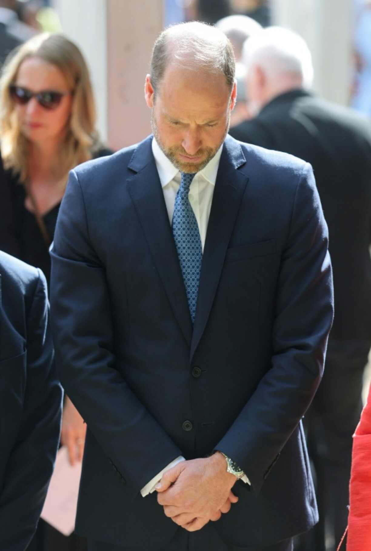 Prince William bows his head in respect at the memorial service