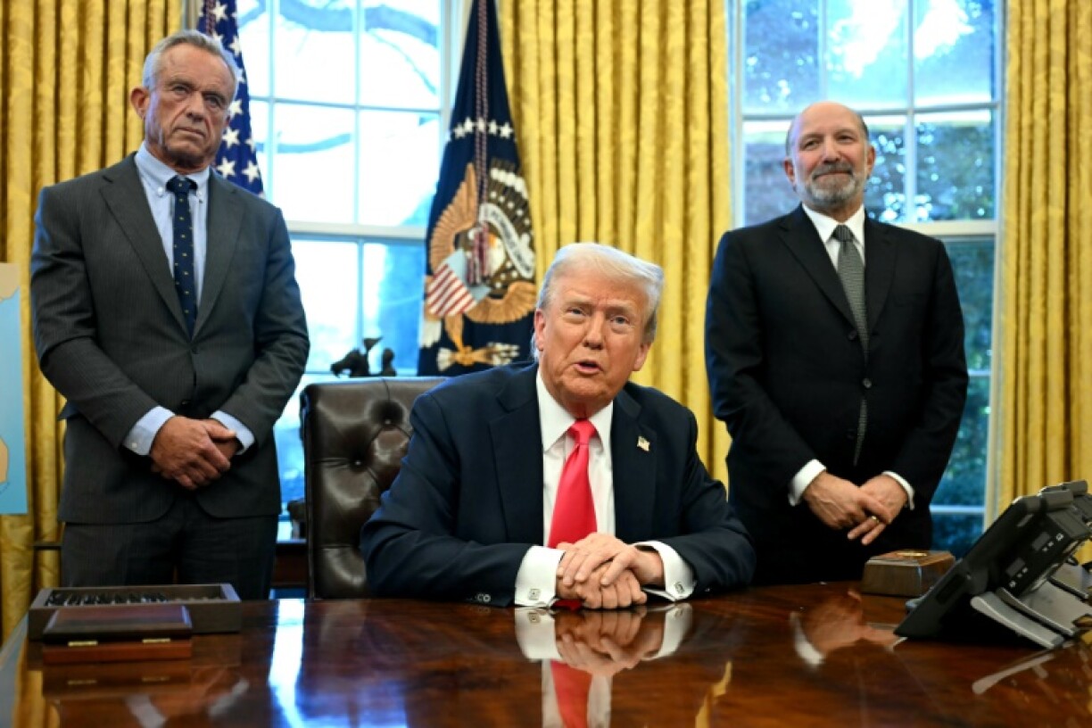 US President Donald Trump speaks to the press alongside Secretary of Health and Human Services Robert F. Kennedy Jr (L) and Secretary of Commerce Howard Lutnick (R) on February 25, 2025