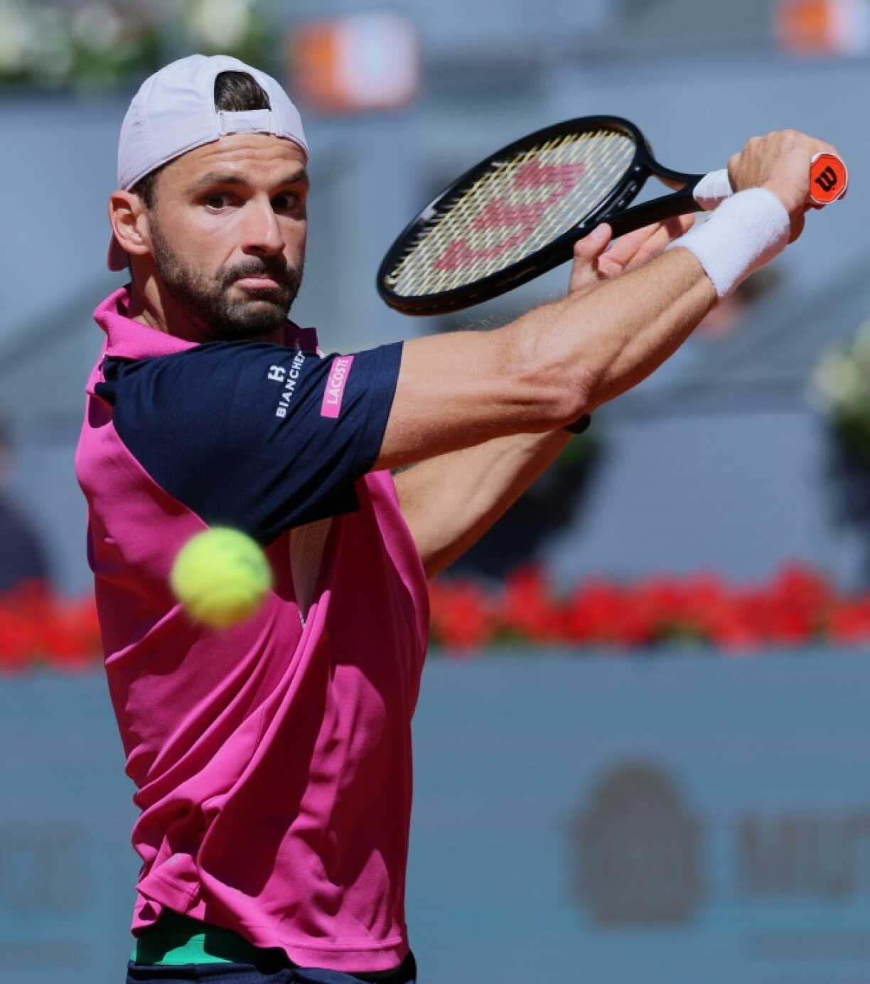 Bulgaria's Grigor Dimitrov converted his third match point some 27 hours after his first to reach the Madrid Open fourth round