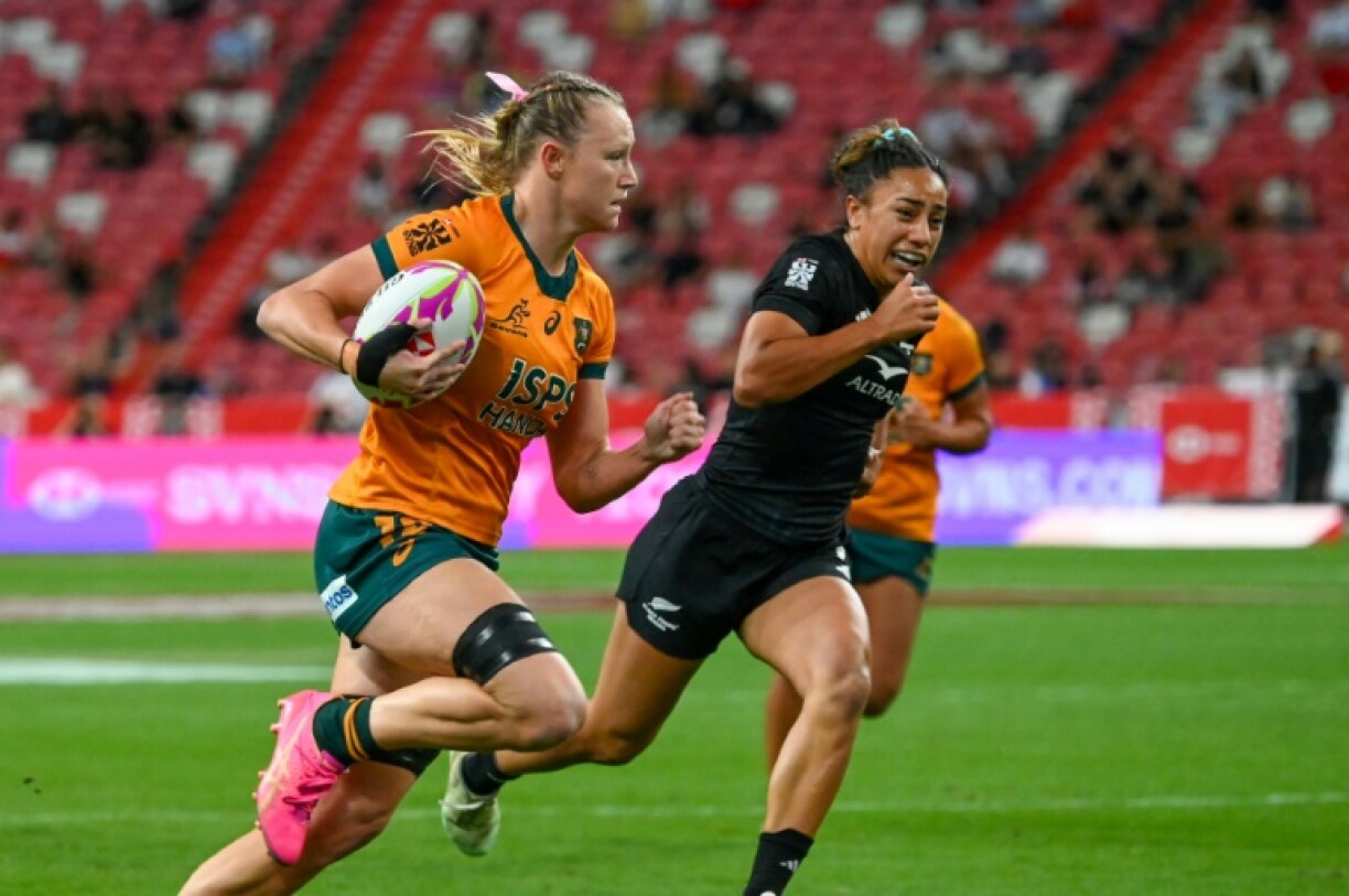 Australia's Maddison Levi runs with the ball during the women's cup final against New Zealand