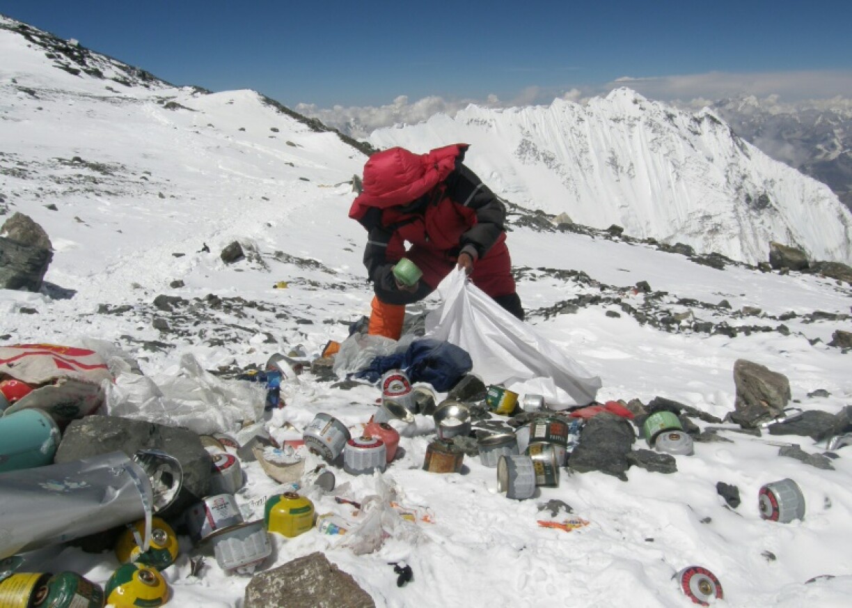 A Nepalese sherpa collects garbage on Mount Everest
