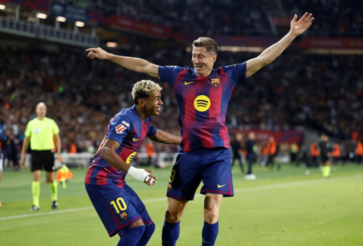 Barcelona's Polish forward Robert Lewandowski celebrates with Lamine Yamal after the winger set him up to score against Real Sociedad