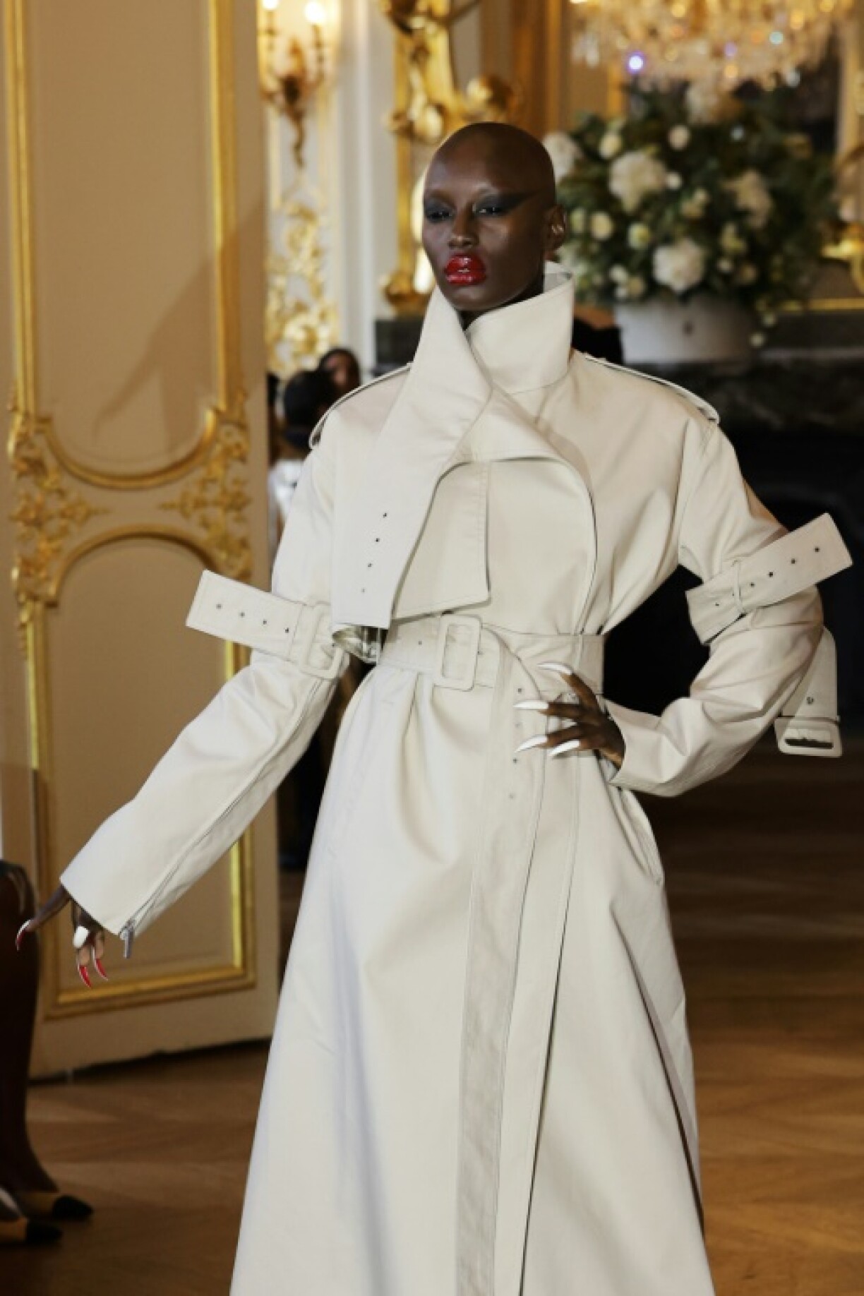 A model presents a trench coat by Matieres Fecales