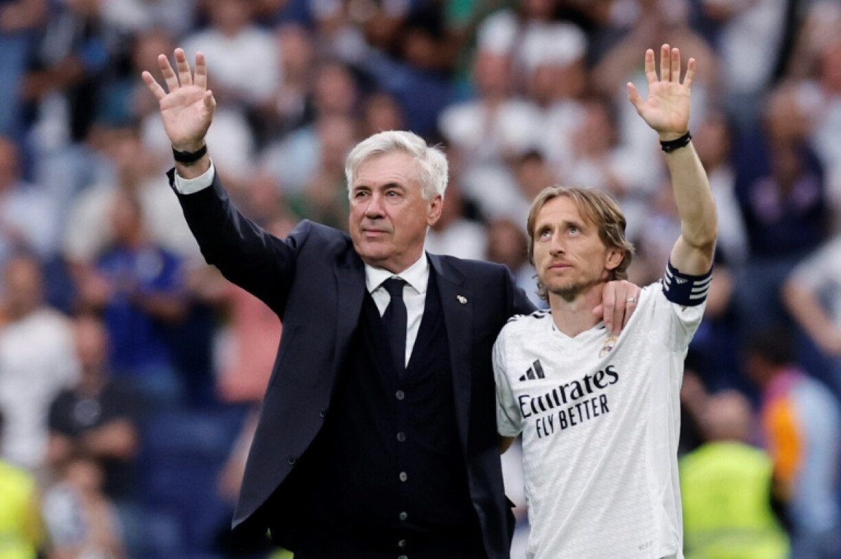 Coach Carlo Ancelotti and midfielder Luka Modric wave to fans at the end of Real Madrid's last home match of the season
