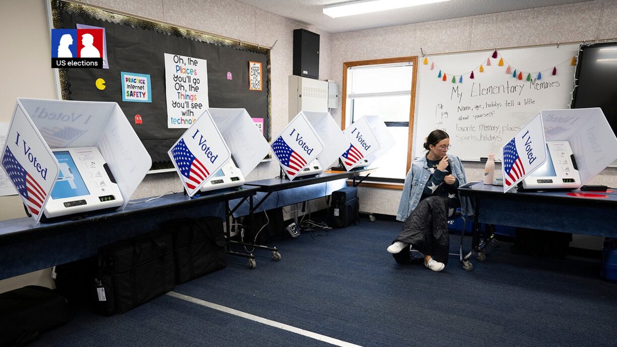 An election official sits next to polling machines at Stiles Point Elementary in Charleston, South Carolina, on 3 February 2024 during the democratic primary.