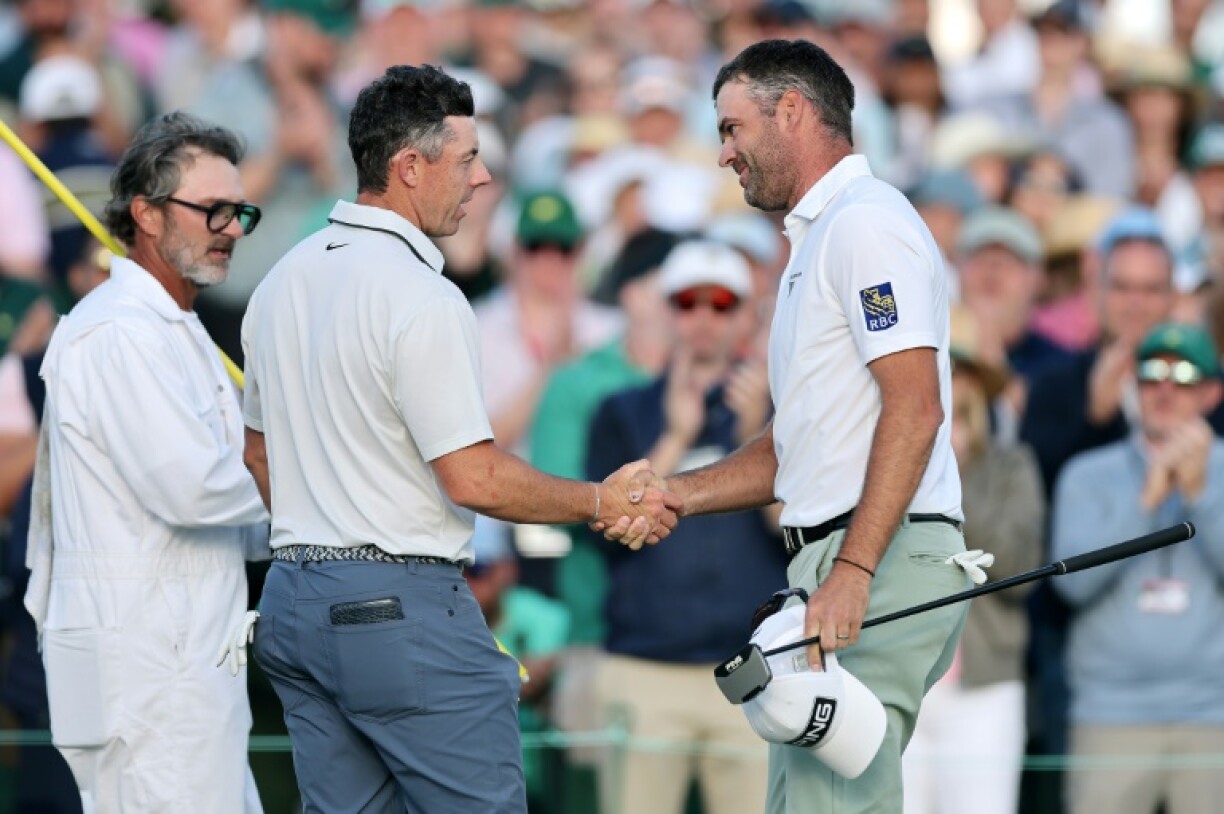 Canada's Corey Conners, at right shaking hands with Rory McIlroy, was among those singing the four-time major winner's praises after he grabbed the 54-hole lead at the Masters