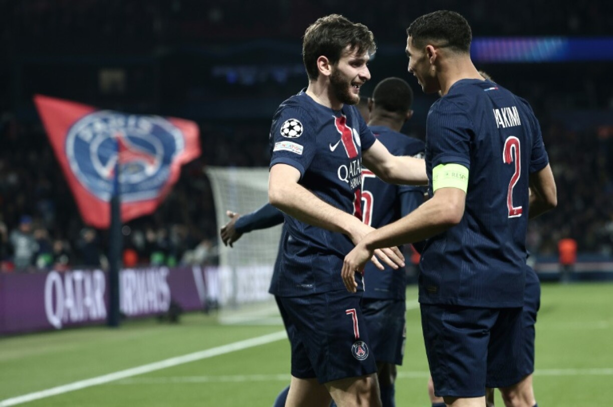 Khvicha Kvaratskhelia celebrates with captain Achraf Hakimi after scoring PSG's second goal against Aston Villa