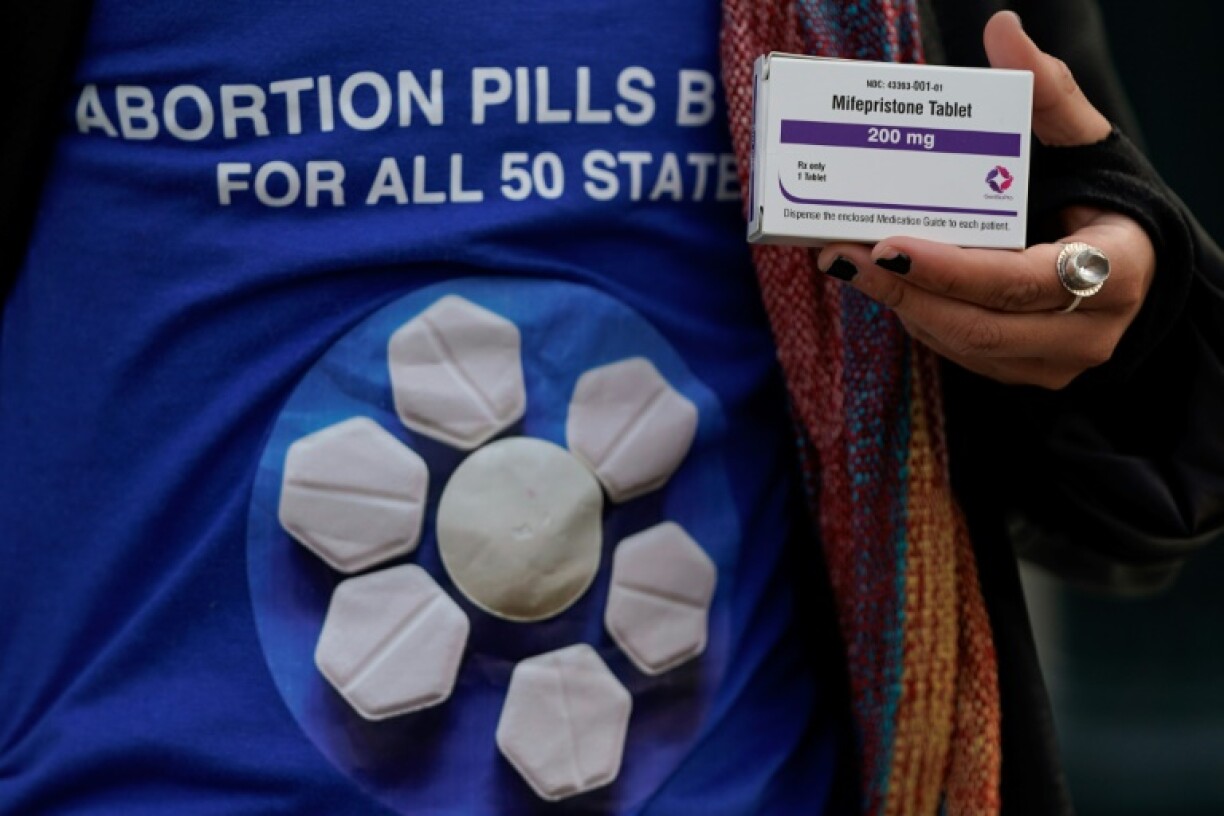 A pro-abortion rights activist holds a box of mifepristone during a rally in front of the US Supreme Court in March 2024 -- the use of such pills is the next front for the anti-abortion movement in the United States