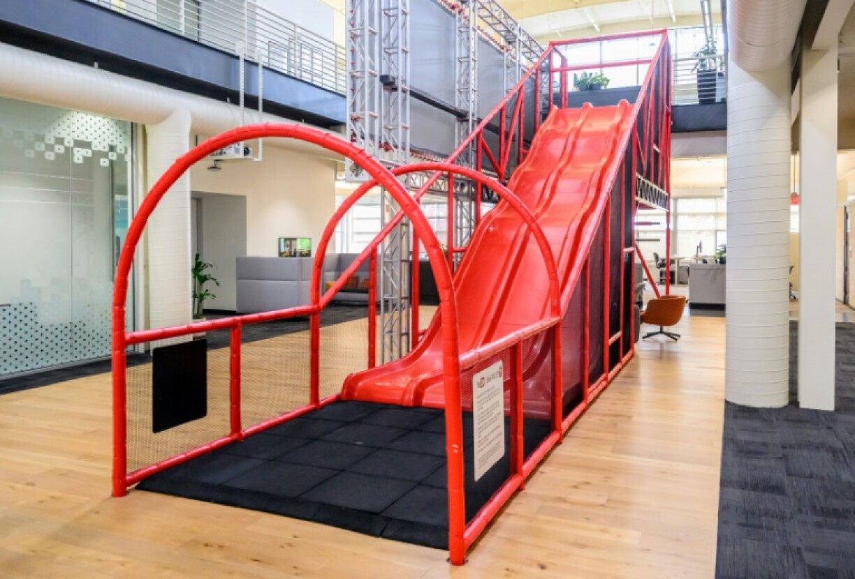 A slide that employees use to zip down to the first a floor inside YouTube's headquarters in San Bruno, California, harkens back to playful early days at the online video sharing platform now challenging traditional television