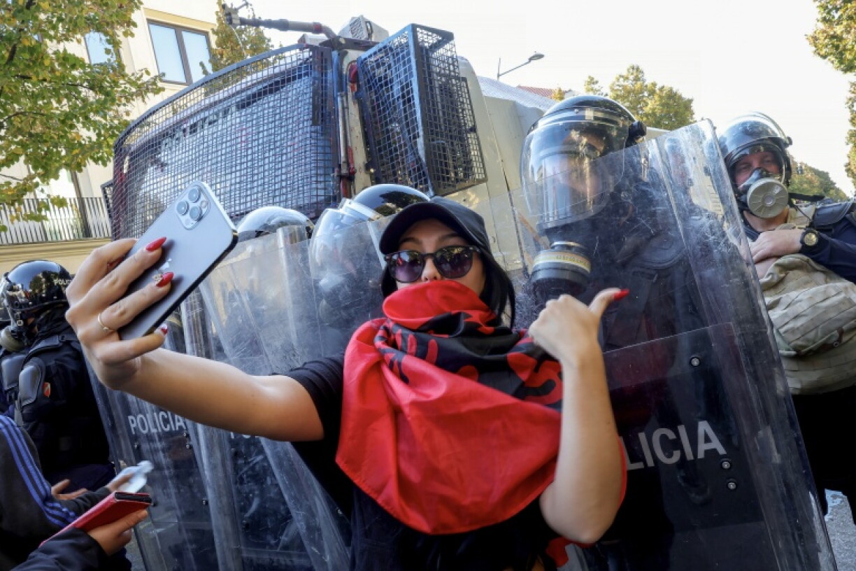 A protester took a selfie with riot police during an anti-government demonstration in Tirana