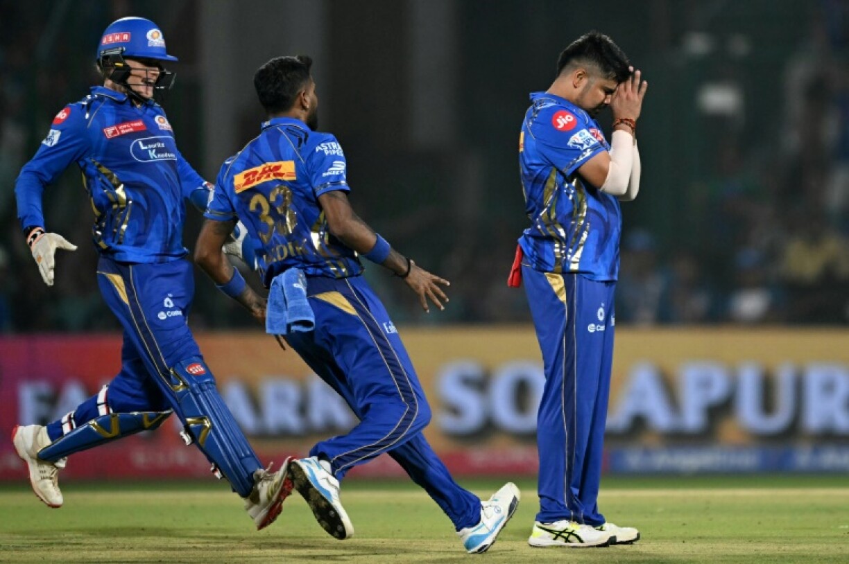 Mumbai Indians' Karn Sharma (R) celebrates taking the wicket of Delhi Capitals' KL Rahul in the IPL