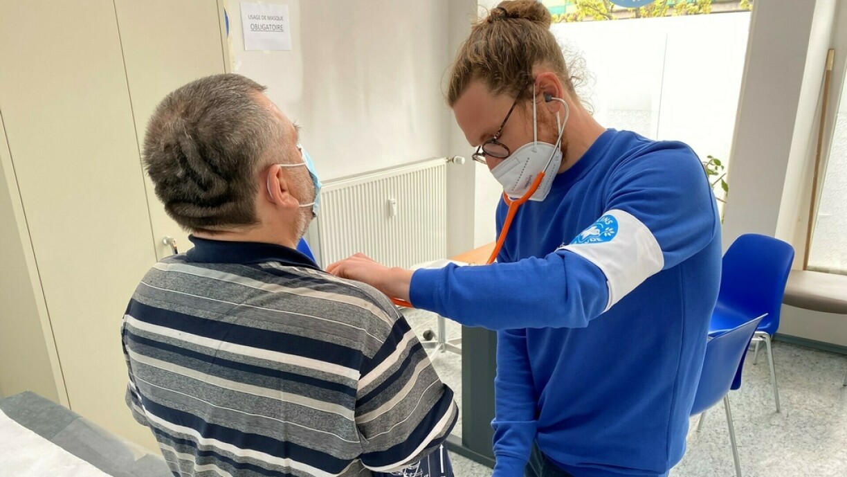 A homeless man receiving a Covid-19 vaccine jab from a volunteer at Doctors of the World.